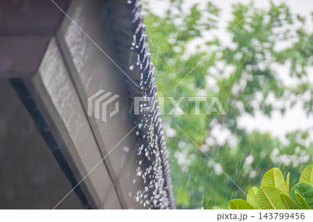 rain falling down from the house roof rain falling down from the house roof 143799456