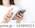 スマートフォンを使う女性の手元 143800523