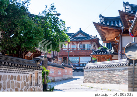 Traditional Korean Hanok Houses and Tiled Roofs against Bukhansan Mountain in Eunpyeong Hanok Village, Seoul Traditional Korean Hanok Houses and Tiled Roofs against Bukhansan Mountain in Eunpyeong Hanok Village, Seoul 143802035