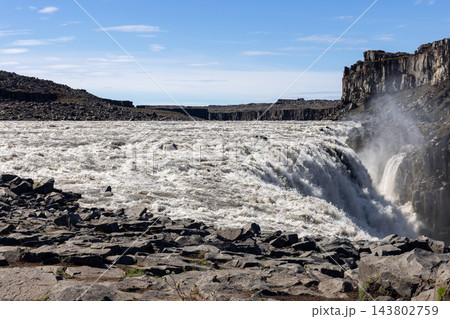 Dettifoss waterfall and turbulent river beside basalt cliffs in North Iceland Dettifoss waterfall and turbulent river beside basalt cliffs in North Iceland 143802759