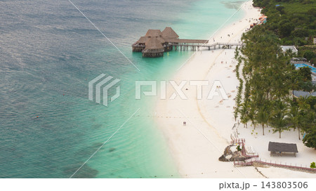Aerial view of bungalow white sandy beach and green ocean in a day time Aerial view of bungalow white sandy beach and green ocean in a day time 143803506