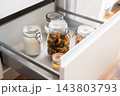 Glass storage jars filled with dry food on modern kitchen countertop 143803793