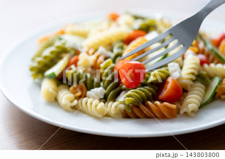 Colorful fusilli pasta salad with fresh vegetables and feta cheese 143803800
