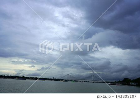 Vidyasagar Setu cable stayed bridge over Hooghly river under dark monsoon clouds in Kolkata Vidyasagar Setu cable stayed bridge over Hooghly river under dark monsoon clouds in Kolkata 143805107