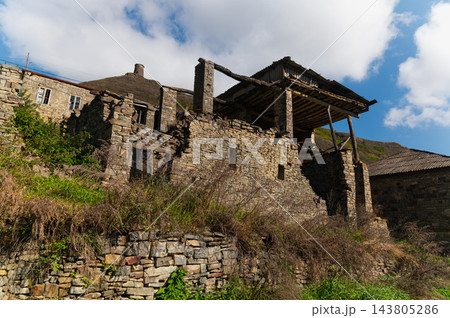 Ruined stone building with tower on mountain hill Ruined stone building with tower on mountain hill 143805286