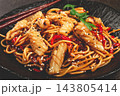 udon noodles, with squid and vegetables, on a black plate, homemade, no people, 143805414