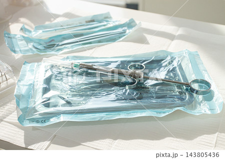 Sterile medical instruments, lying on a tray in protective packaging, dentist's instruments, preparation for a medical procedure. Sterile medical instruments, lying on a tray in protective packaging, dentist's instruments, preparation for a medical procedure. 143805436