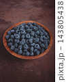 fresh blueberries, in a wooden bowl, on the table, top view, close-up, no people, 143805438