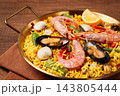 Seafood paella, in a frying pan, on a wooden table, no people, 143805444
