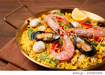 Seafood paella, in a frying pan, on a wooden table, no people, Seafood paella, in a frying pan, on a wooden table, no people, 143805444