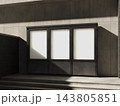 Blank three framed poster displays on a sunlit stone wall 3D render 143805851