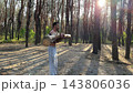 Hardy shirtless sportsman lifting wooden log at summer forest. Young athletic guy exercises with hard weight training biceps. Strong muscular man working at sunny woodland. Active lifestyle concept 143806036