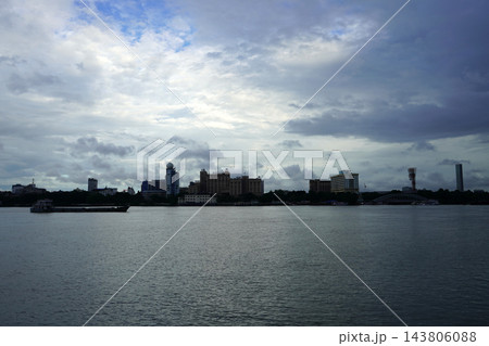 Kolkata city skyline along the wide Hooghly river under a cloudy dramatic sky Kolkata city skyline along the wide Hooghly river under a cloudy dramatic sky 143806088