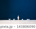 Teamwork, collaboration and belonging concept with businessman among TEAM letters 143806090
