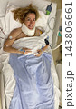 Woman Lying in Hospital Bed Receiving Medical Care and Treatment Woman Lying in Hospital Bed Receiving Medical Care and Treatment 143806661