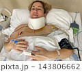 Woman Lying in Hospital Bed Receiving Medical Care and Treatment Woman Lying in Hospital Bed Receiving Medical Care and Treatment 143806662