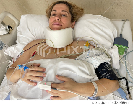 Woman Lying in Hospital Bed Receiving Medical Care and Treatment 143806662