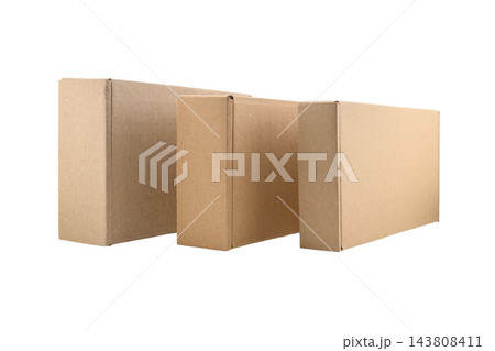 three cardboard boxes standing side by side on their edges on a white isolated background 143808411