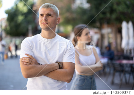 guy is offended by his girlfriend and is standing on the street guy is offended by his girlfriend and is standing on the street 143809377