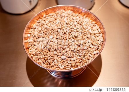 Bowl of toasted grain cereal on a metallic surface in Kangding Shi Bowl of toasted grain cereal on a metallic surface in Kangding Shi 143809883