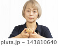 手作りパンを楽しむシニア女性の手元クローズアップ 143810640