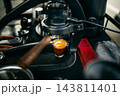 Barista brewing specialty coffee using a manual lever espresso machine at a slow bar. 143811401