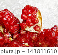 Close up fresh juicy red pomegranate arils on crushed ice 143811610