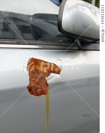 Close up rusty corroded metal paint peel on car door 143811611
