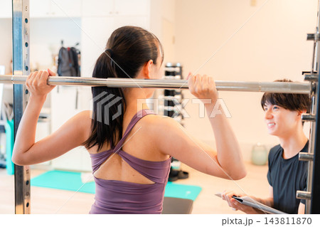 パーソナルトレーニングでコーチ指導を受ける女性 パーソナルトレーニングでコーチ指導を受ける女性 143811870