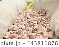 A narrow trench is filled with gravel stones to ensure proper drainage at the construction site. Various construction materials and tools are visible around the area. 143811876