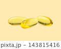 Omega 3. Three smooth softgel capsules of omega 3 fish oil placed on a soothing backdrop. 143815416