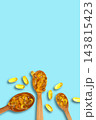 Omega 3. Golden omega fish oil capsules arranged in wooden spoons. Health supplement concept. 143815423