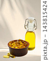 Omega 3. Glass bottle and bowl filled with fish oil capsules on soft backdrop. 143815424