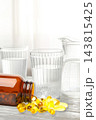 Omega 3. Omega fish oil capsules are scattered next to clear glasses of water. 143815425