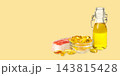 Omega 3. Salmon fillet sits next to a bowl of omega fish oil capsules and a bottle of oil. 143815428