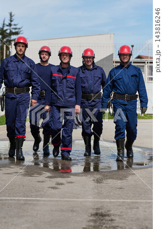 Brave Firefighters Team Walking Together In Uniforms With Red Helmets And Protective Gear 143816246