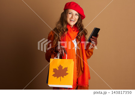 Smiling Woman with Autumn Shopping and Phone 143817350