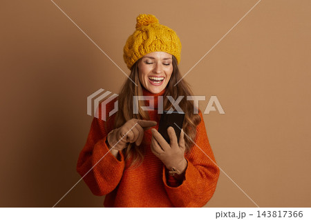 Joyful Woman Pointing to Smartphone Screen Joyful Woman Pointing to Smartphone Screen 143817366