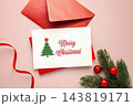 Merry christmas white card with red envelop and xmas decoration on pink background, top view 143819171