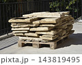 Stacked natural stone tiles on a wooden pallet outdoor 143819495
