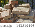 Stack of old rustic clay bricks on a construction site 143819496