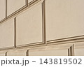 Classic stucco wall texture with embossed rectangular block patterns 143819502