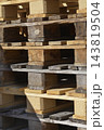 Stacked wooden pallets in outdoor storage yard 143819504