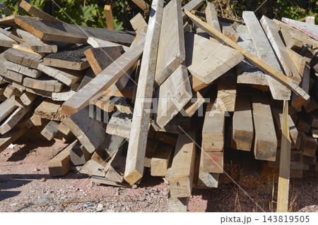 Pile of old construction lumber and wooden beams Pile of old construction lumber and wooden beams 143819505