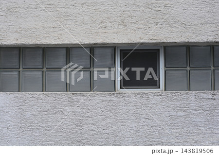 Glass block window window on textured facade wall Glass block window window on textured facade wall 143819506
