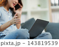 Pregnant remote worker takes a phone call at home 143819539