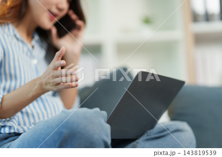 Pregnant remote worker takes a phone call at home Pregnant remote worker takes a phone call at home 143819539