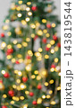 Christmas tree with blurred golden lights and red ornaments 143819544