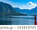 Hallstatt, Austria resort Alpine Lake Landscape with Mountains and Red Parasol 143819745