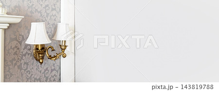 Vintage brass wall sconce on damask wallpaper Vintage brass wall sconce on damask wallpaper 143819788